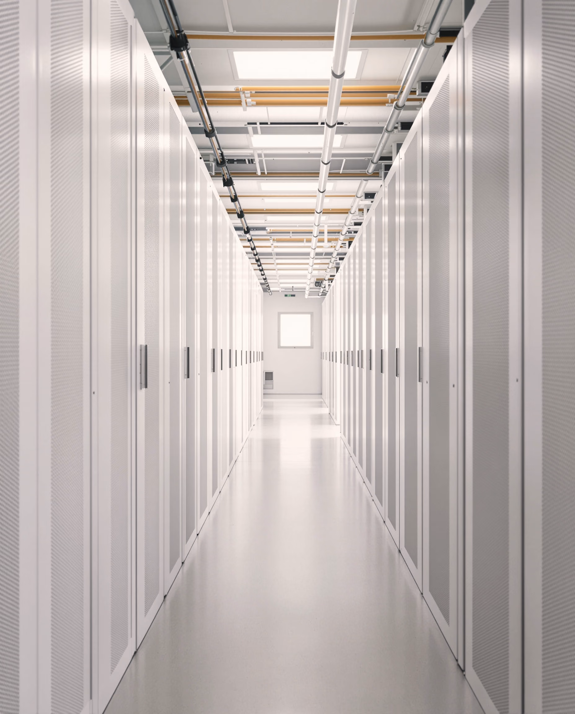 A row of equipment racks along a pale machine room lit evenly from one side
